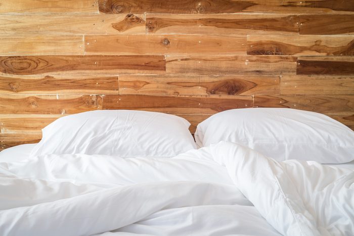 Close up white bedding sheets and pillow, Messy bed concept