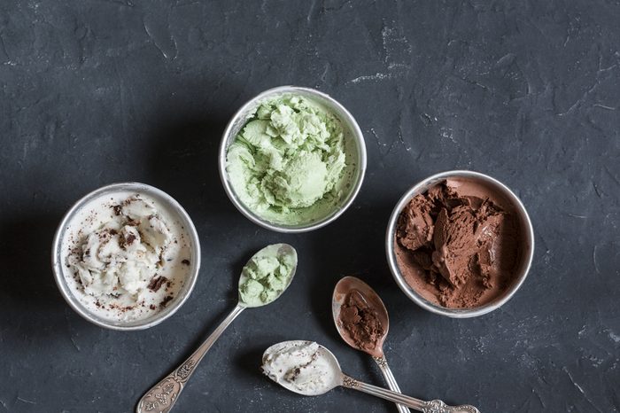 Range of coconut milk ice cream with chocolate, matcha powder, chocolate chips and vanilla. On a dark background, top view. Gluten free vegetarian dessert