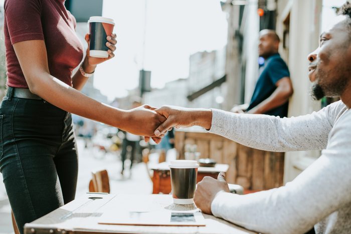 African couple shaking hands together