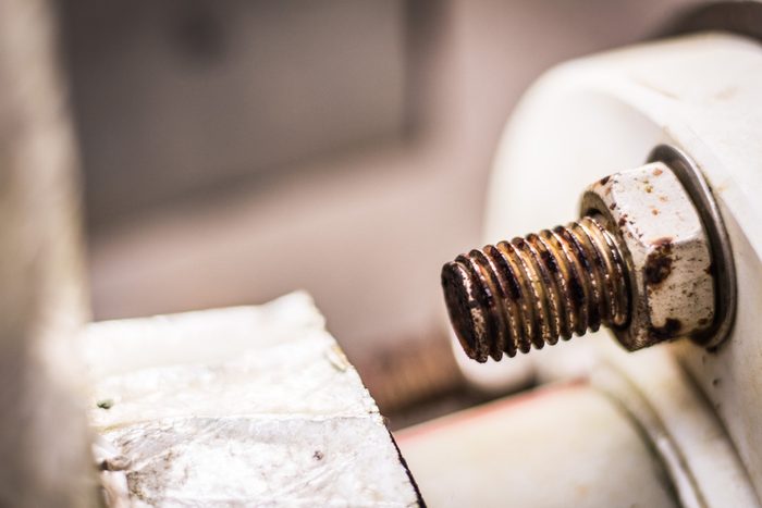 Rusty bolt and nut of water heater pipe, Texture of rust with blur background.