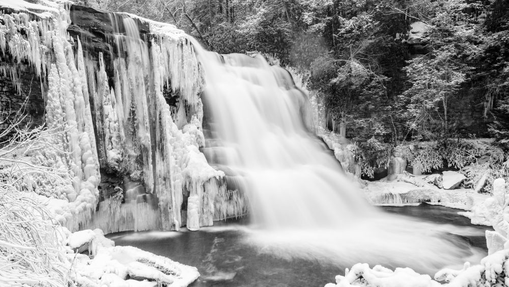 Muddy Creek Falls. The massive water movement of this stunning water fall contrasts with the frozen landscape surrounding it.