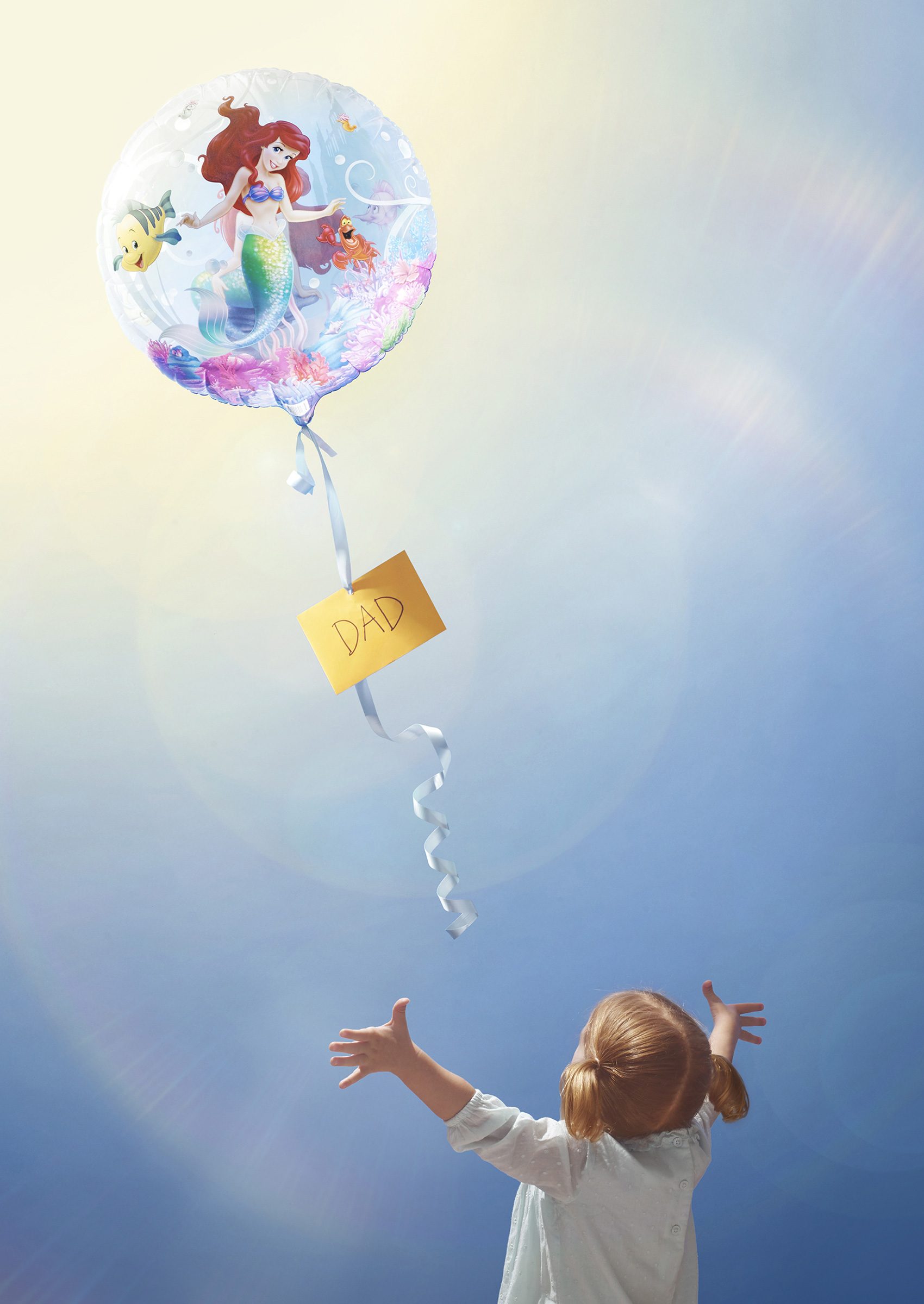 little girl reaching for balloon