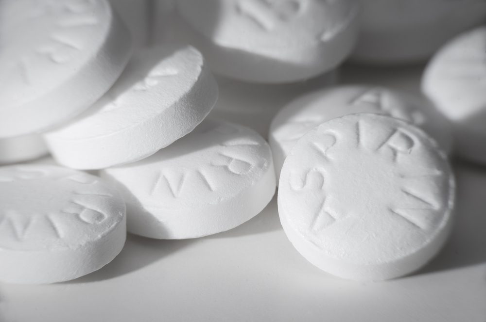 Macro shot of white asiprin on white background.