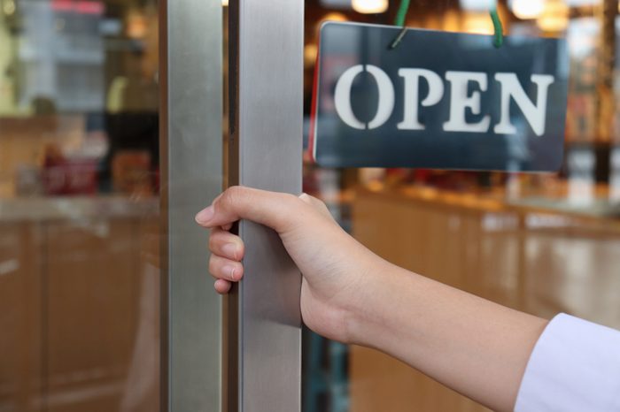 hand on handle door for open to entering restaurant 