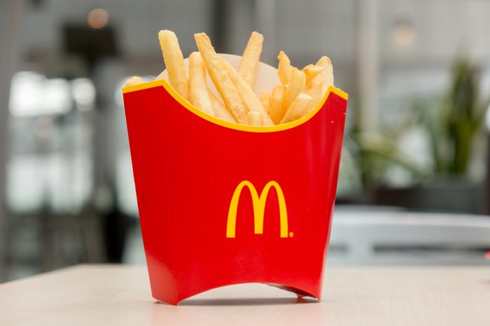 Moscow, Russia, March 15 2018: McDonald's potato french fries in the red box on wooden background