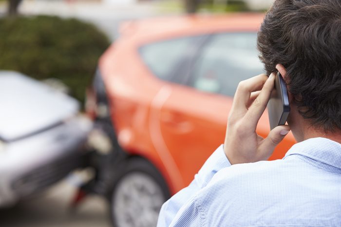 Teenage Driver Making Phone Call After Traffic Accident