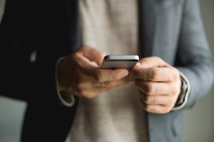 Businessman Typing on smart phone