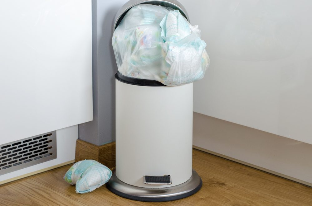 garbage can full of used dirty diapers