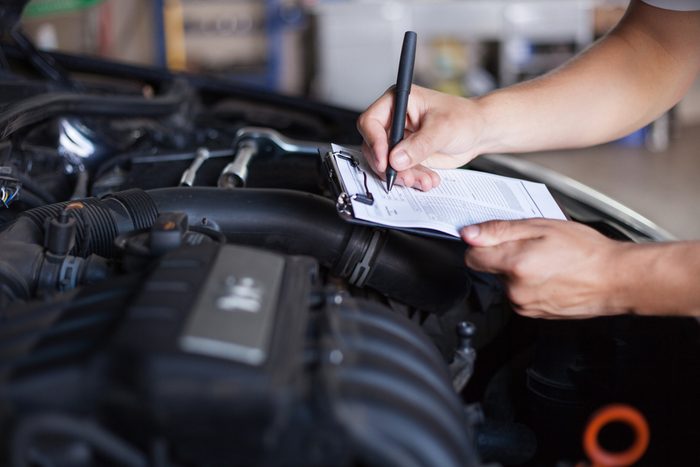 mechanic repairman inspecting car