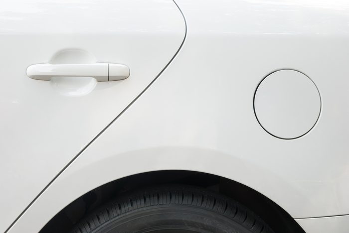 door and tyre and petrol cap cover of a white car