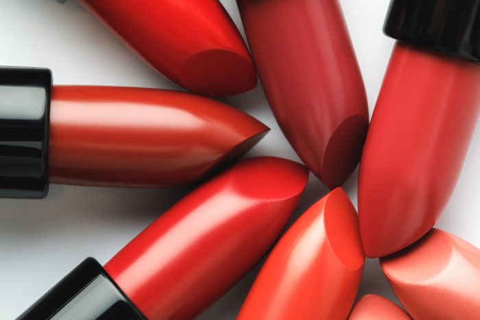 close-up shot of red lipsticks of different shades on white tabletop