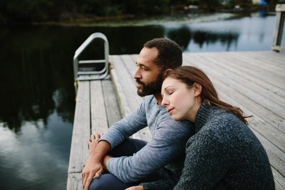 Man and woman sitting on a dock