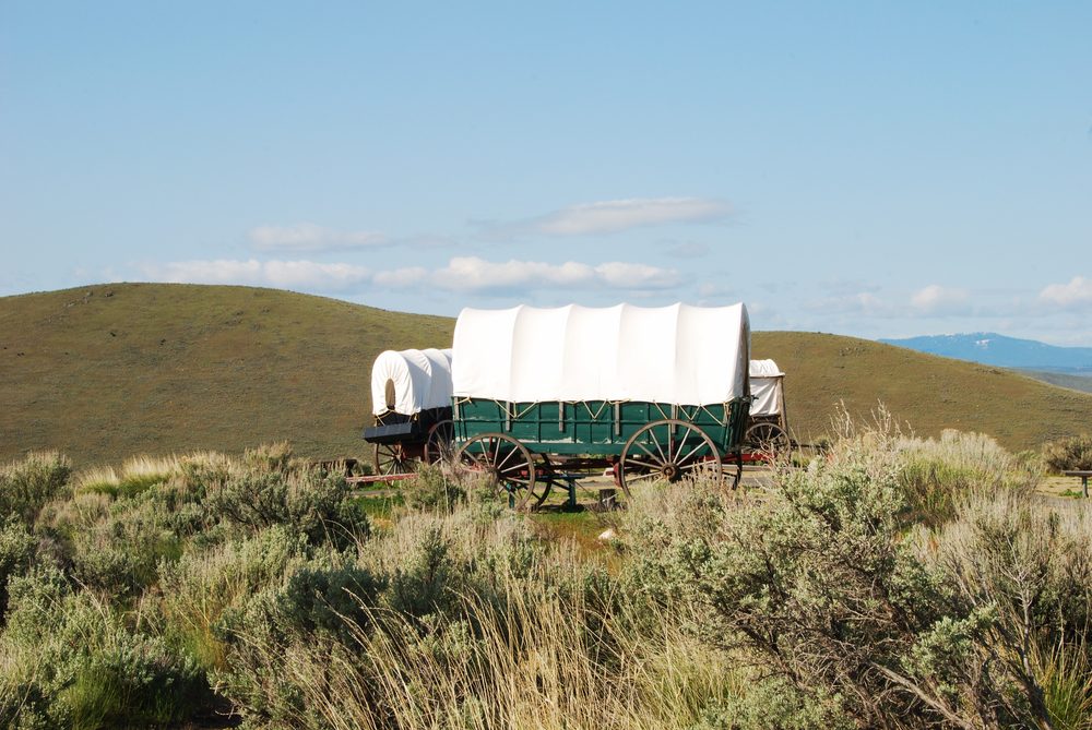 The National Historic Oregon Trail Interpretive Center near Baker City Oregon.  Wagons at the Center with the Blue Mountains in the background