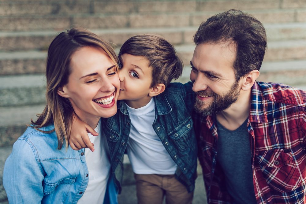 Happy family is having fun outdoors. Father, mother and son are spending time together.