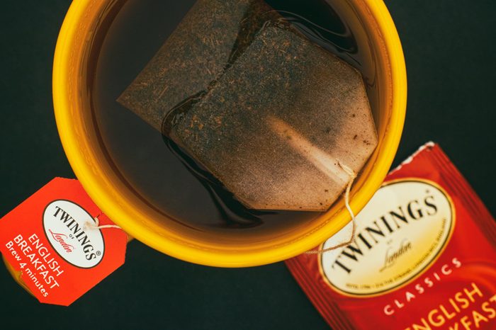 Tambov, Russian Federation - August 28, 2017 Cup of Twinings English Breakfast tea with teabag. Black background. Top view. Studio shot.