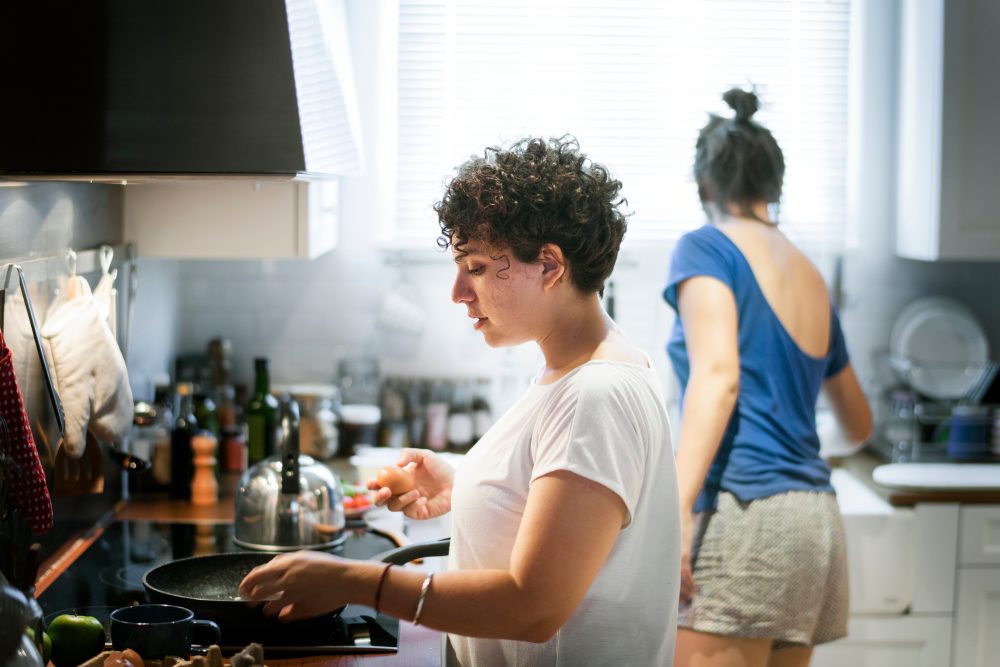 Lesbian couple cooking in the kitchen together