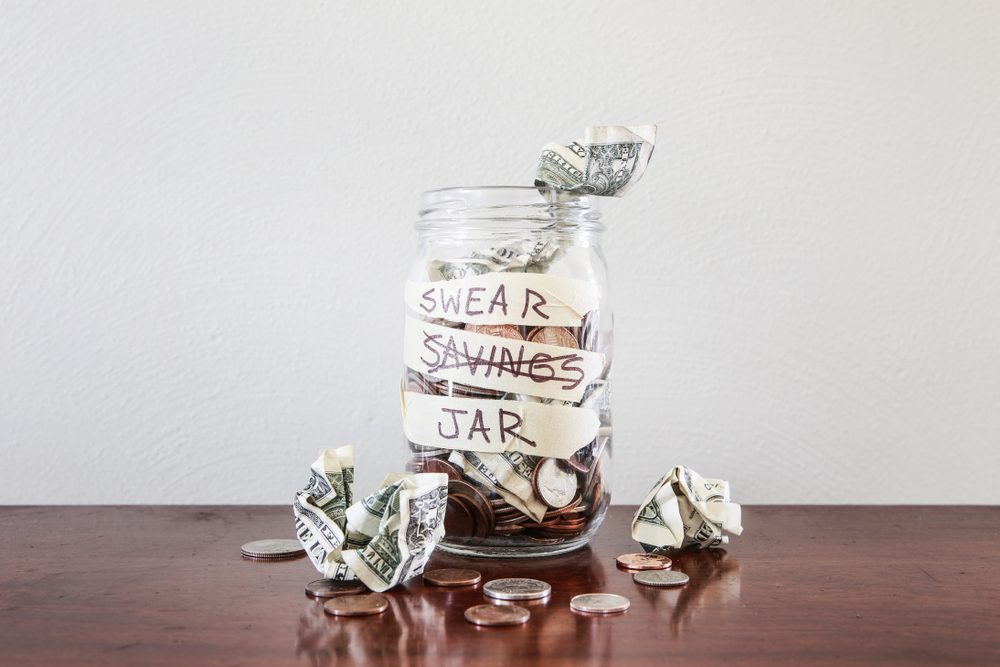 Swear jar to prevent swearing, filled with money