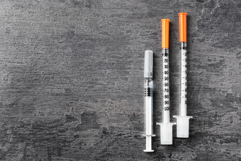 Medical syringe on grunge background. Vaccination concept