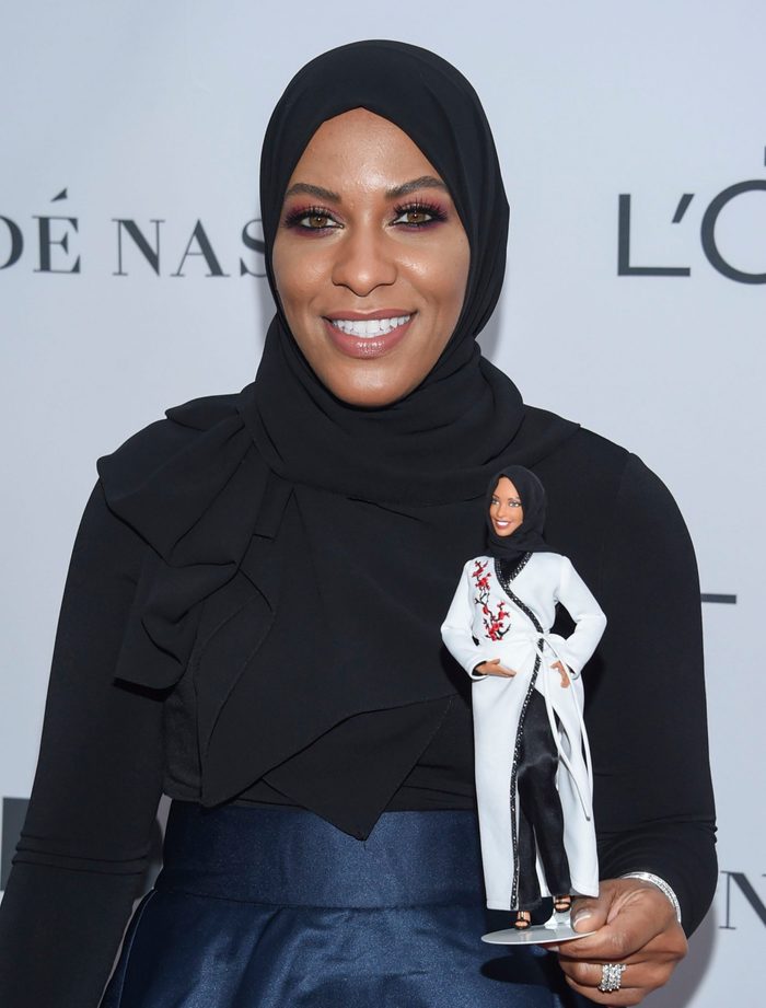 Ibtihaj Muhammad holds a hijab-wearing "Barbie Shero"