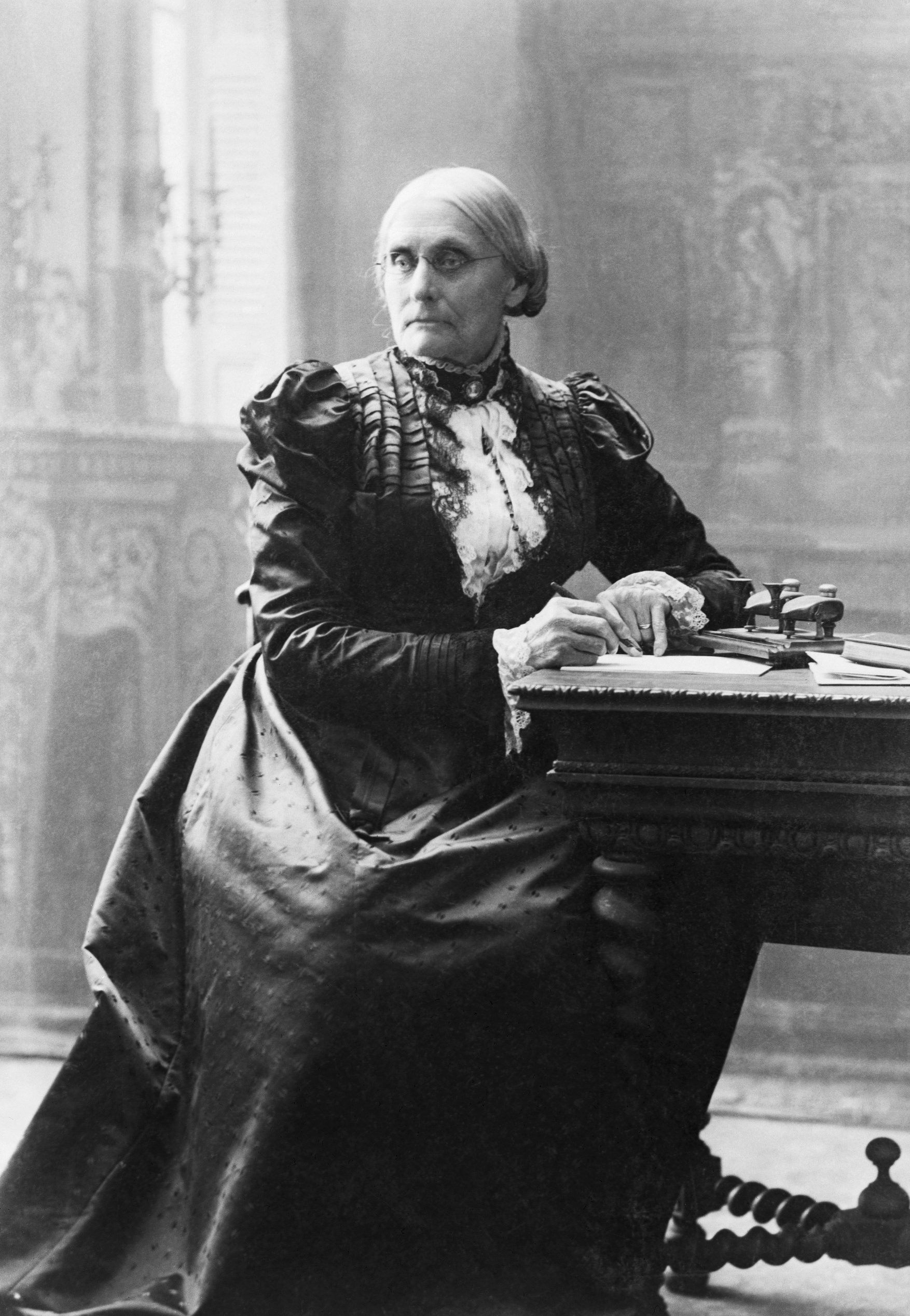 Suffragist Susan B. Anthony (1820-1906), seated at her desk.