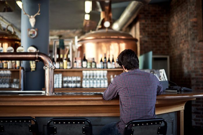 Rearview shot of a man sitting at a bar counter