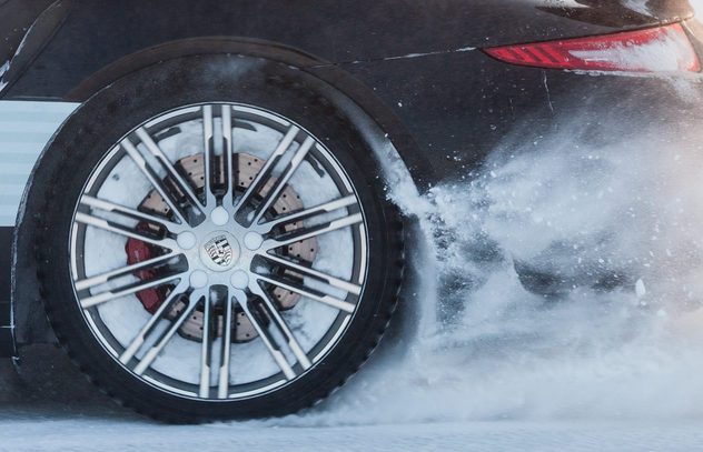 LEVI, FINLAND - FEB 20: Rear wheel spin of a PORSCHE 911 TURBO car during Porsche Driving Experience Snow & Ice Press Event on February 20, 2014 in LEVI, FINLAND