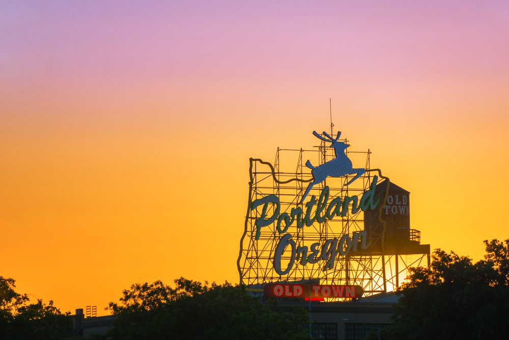 Sunset over the iconic Portland, Oregon Old Town sign in downtown Portland, Oregon