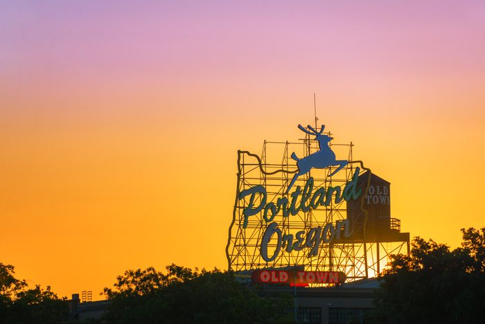 Sunset over the iconic Portland, Oregon Old Town sign in downtown Portland, Oregon