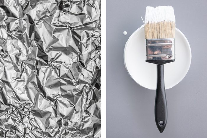 Aluminum foil texture next to used paintbrush
