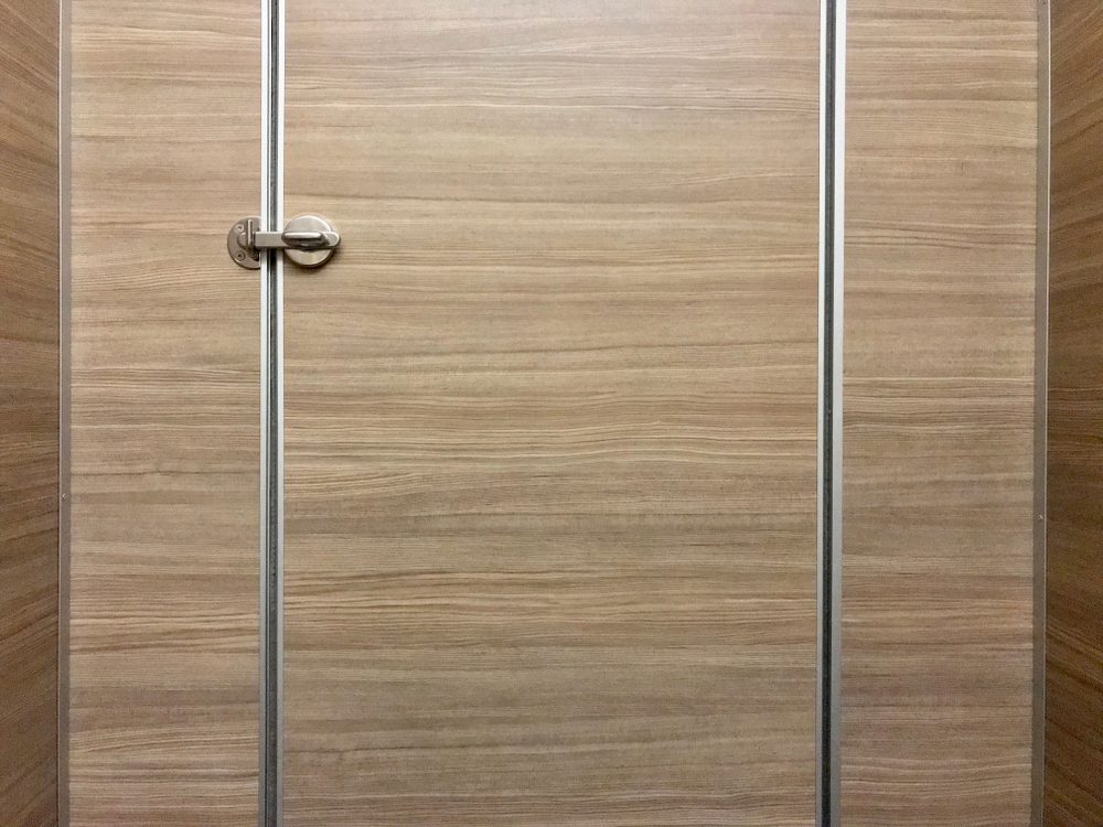 Stainless steel door knob, closed wooden door, locked door, public toilet door