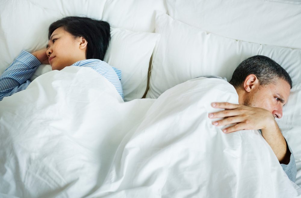 Couple on a bed having a problem