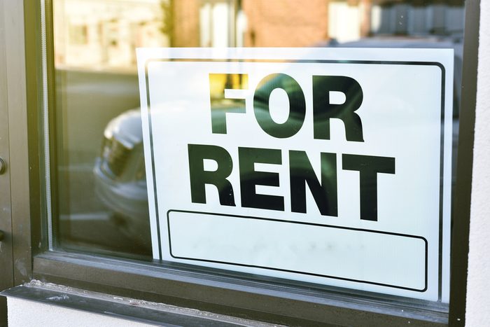 for rent sign for business in window with sunny reflection