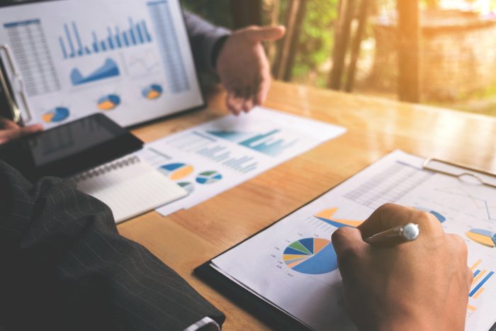 Co working conference, Business team meeting present, investor colleagues discussing new plan financial graph data on office table with laptop and digital tablet, Finance, accounting, investment.