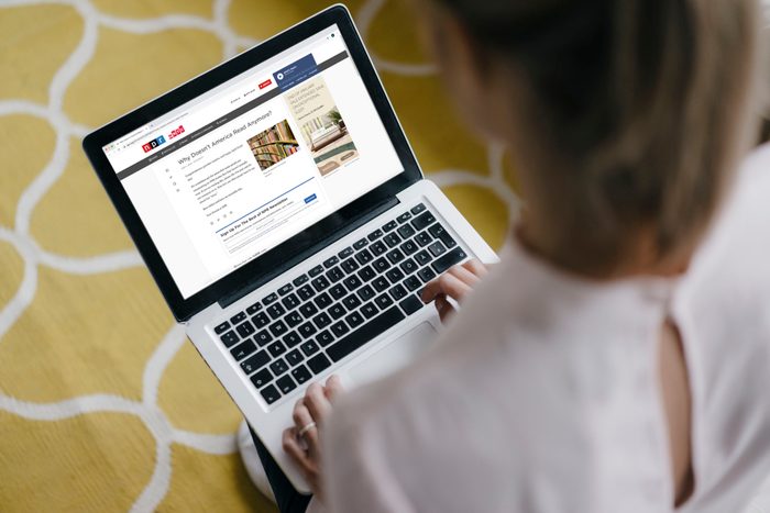 woman reading NPR article on laptop
