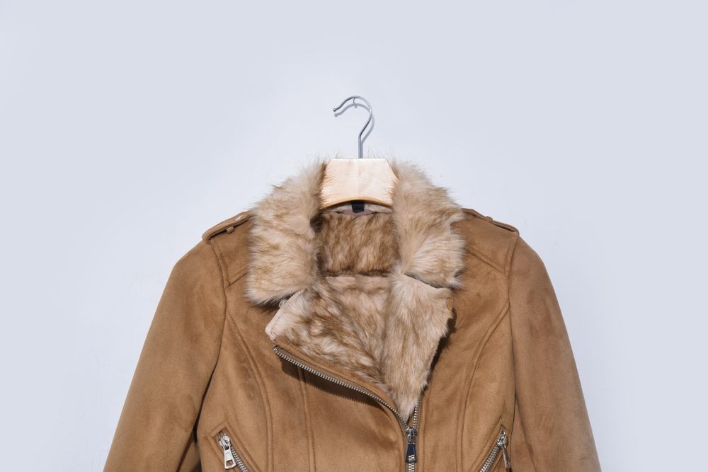 Warm winter jacket isolated on a white background. Women clothes coat Of artificial leather and fur