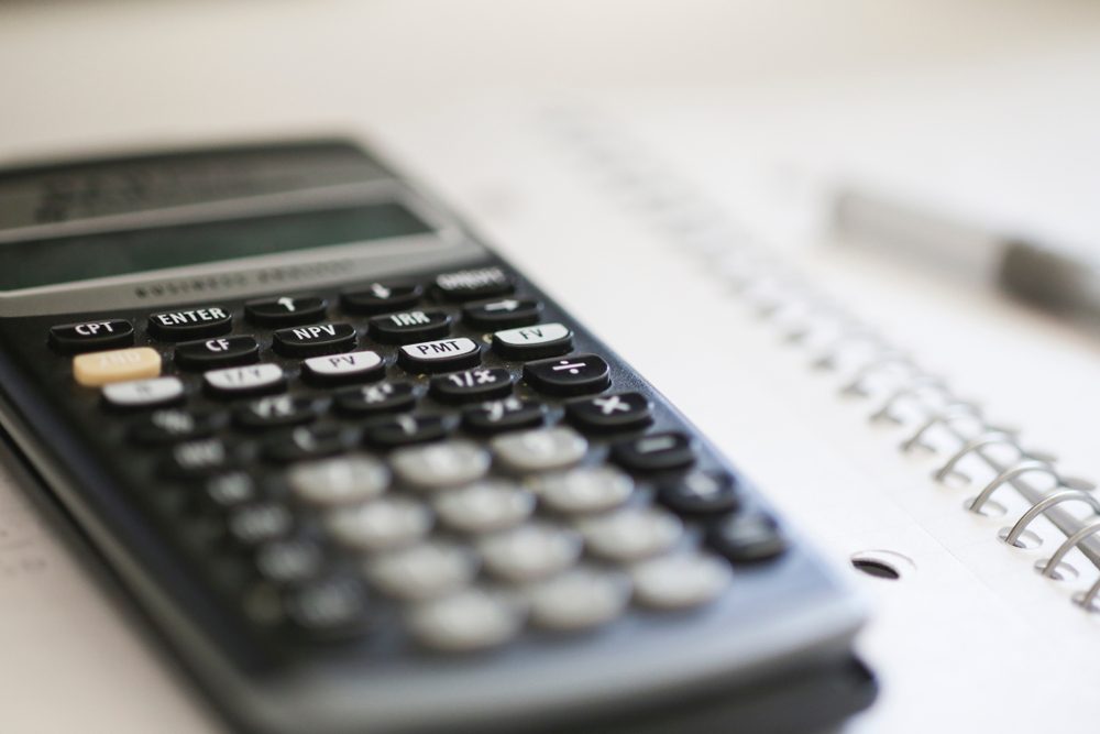 Homework background. Super close up of a calculator on a notebook. 