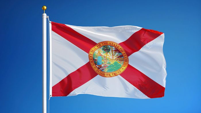 Florida (U.S. state) flag waving against clear blue sky, close up, isolated with clipping path mask alpha channel transparency, perfect for film, news, composition