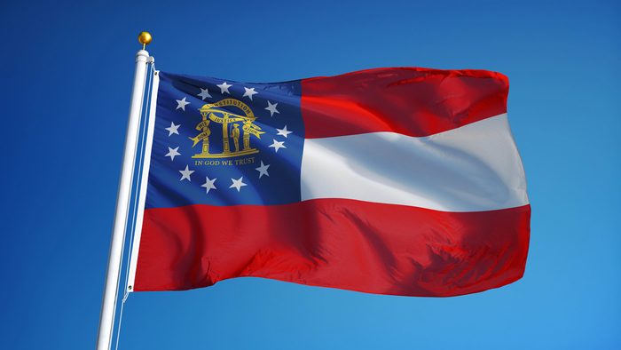 Georgia (U.S. state) flag waving against clean blue sky, close up, isolated with clipping path mask alpha channel transparency with black and white matte