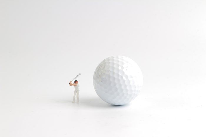 the mini figure play golf on big golf