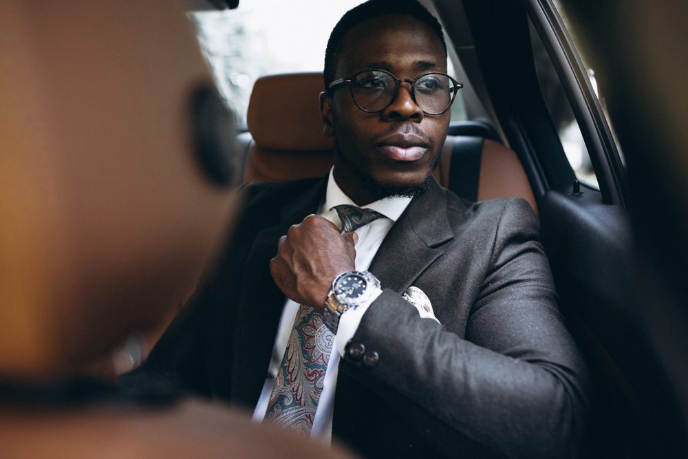 African american business man in car