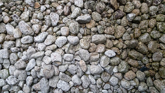 White rock were sprinkled on ground which is Japanese stone garden style Beside it is the part of the water that drips down and causes the rock to form lichen.