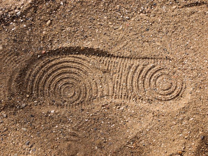 Photo of a shoe print in sand