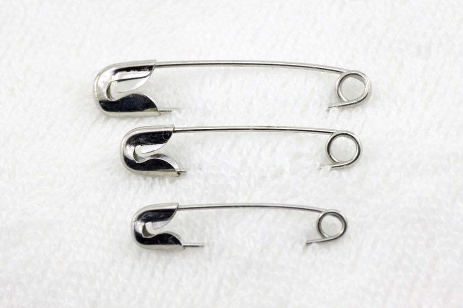 Three safety pins on fabric