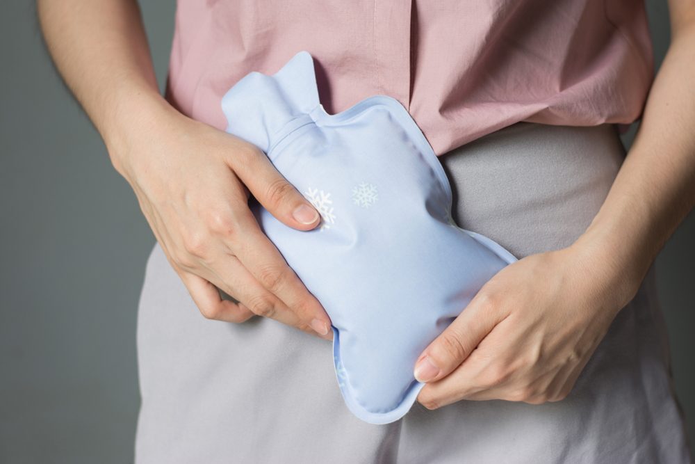 Close up woman has abdominal pain, woman's belly with hot water bottle,Close up woman use Hot Pack