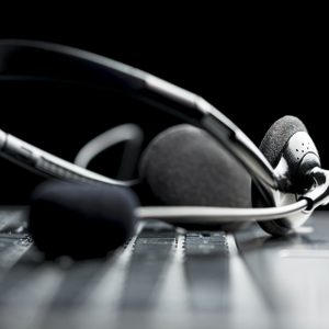 Headset lying on a laptop computer keyboard conceptual of online communication or a call centre, low angle view