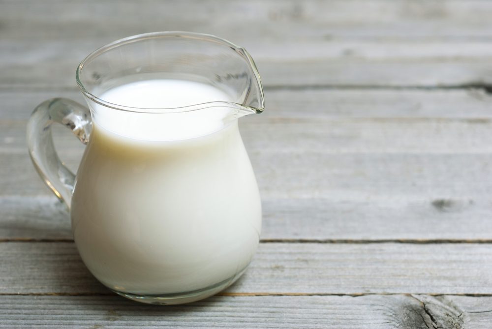 a jug of milk on wooden table