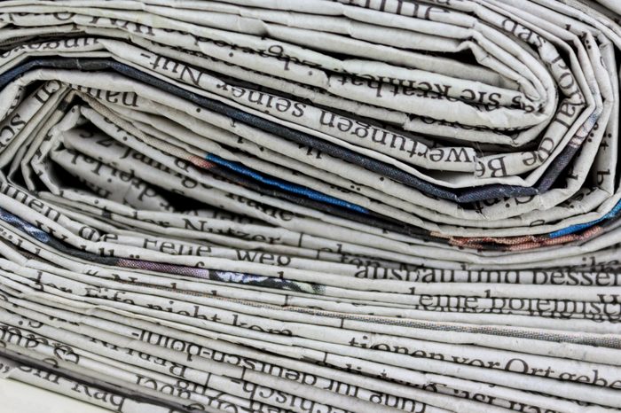 stacked old newspapers pile of newspapers