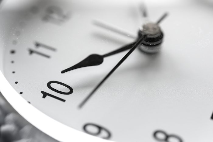 Close up on clockwise.face of silver antique vintage grandfather clock.