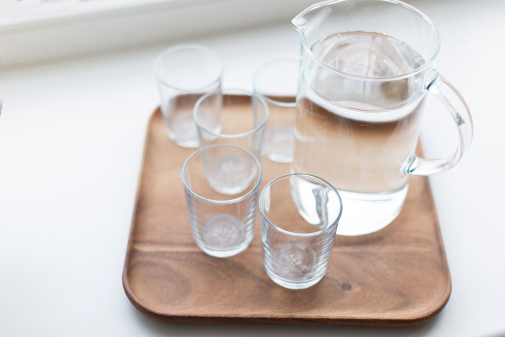 Glass decanter with water and glasses. Close up.