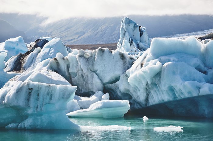 Beautiful vibrant picture of icelandic glacier and glacier lagoon with water and ice in cold blue tones, Iceland, Glacier Bay, icebergs in the water